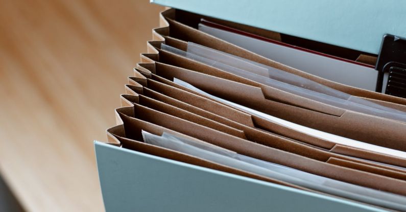 Business Case - From above of opened modern briefcase with prepared papers placed on timber table in soft focus