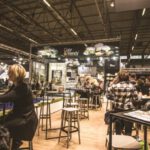 Networking - People Inside a Cafe With Tables and Chairs