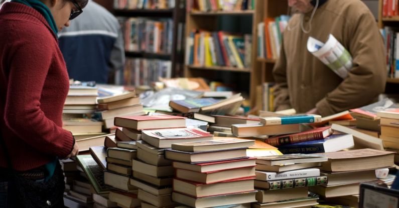 Customer Case Studies - Woman and Man Standing Beside Piles of Books