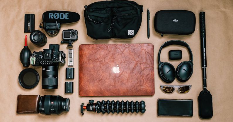 Business Case - Overhead view of laptop and photo camera composed with headphones and other gadgets of professional photographer