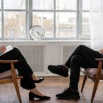 Sensitivity Analysis - Person in Black Pants and Black Shoes Sitting on Brown Wooden Chair