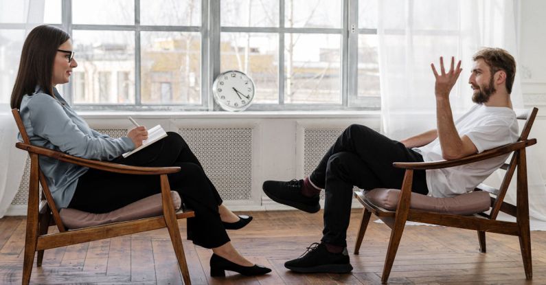 Sensitivity Analysis - Person in Black Pants and Black Shoes Sitting on Brown Wooden Chair