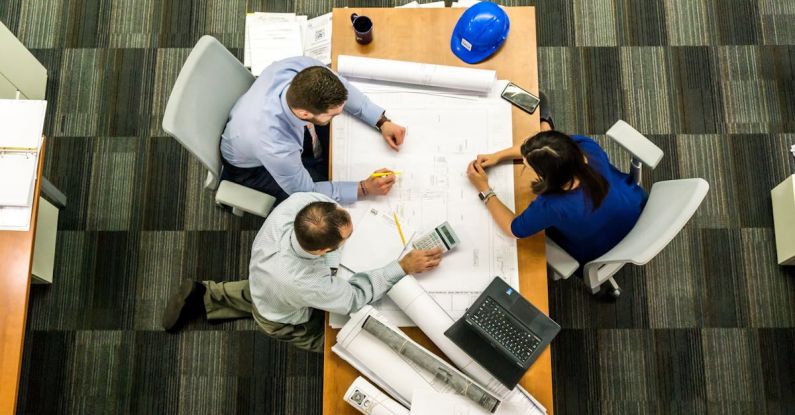 Management Principles - Three People Sitting Beside Table