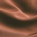 Hawthorne Effect - From above of elegant brown draped silk fabric with smooth texture as abstract background