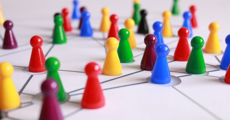 Servant Leadership - Close Up Photography of Yellow Green Red and Brown Plastic Cones on White Lined Surface