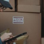 Just-In-Time Inventory - Woman in Black Jacket Holding Black Tablet Computer