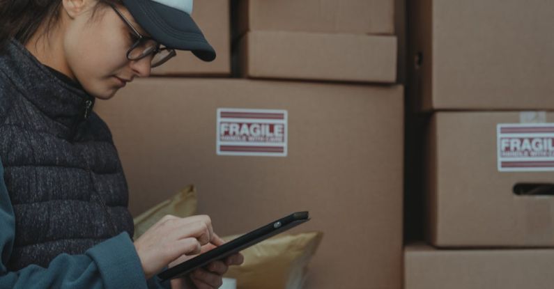 Just-In-Time Inventory - Woman in Black Jacket Holding Black Tablet Computer