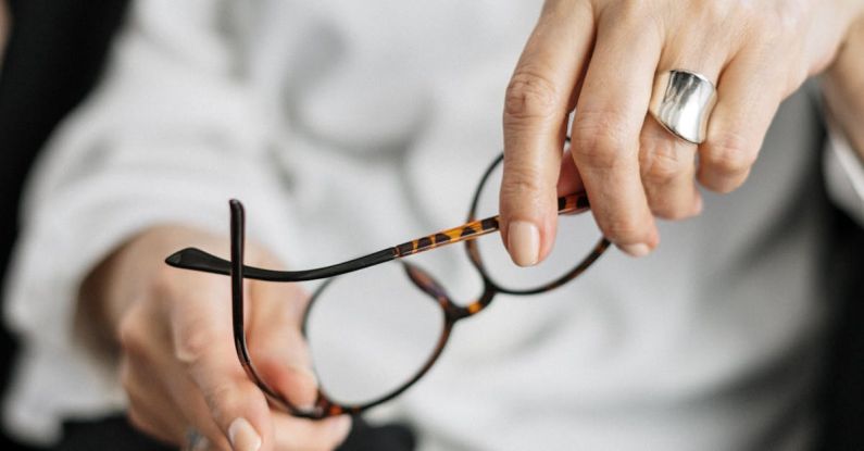 DuPont Analysis - Person Holding Brown Framed Eyeglasses