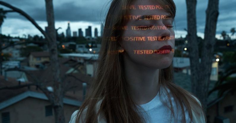 Stress Testing - Calm woman with Positive Tested words on face on roof against cityscape