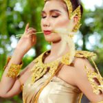 Organizational Culture - Woman in a Traditional Costume with Golden Jewelry Posing in a Park