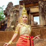 Organizational Culture - Woman in a Traditional Costume Standing in front of a Temple