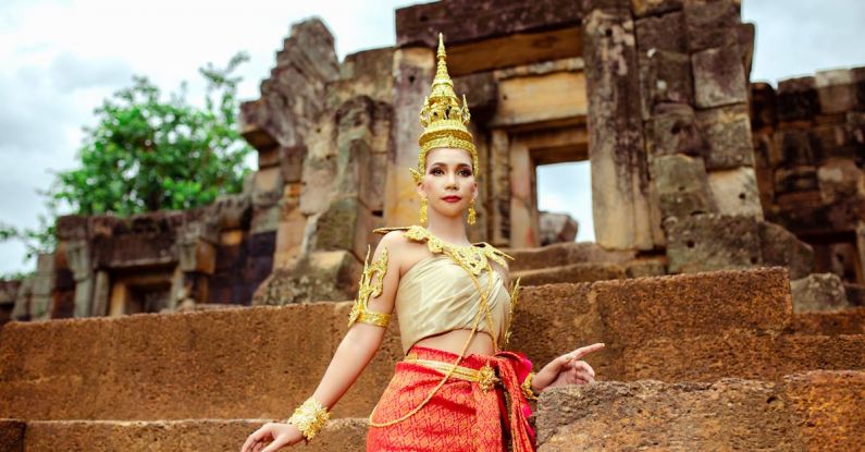 Organizational Culture - Woman in a Traditional Costume Standing in front of a Temple