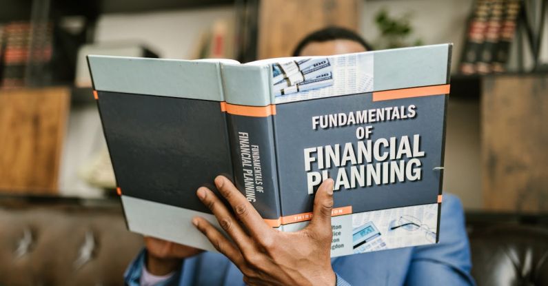 Business Fundamentals - Person Reading a Book About Fundamentals of Financial Planning